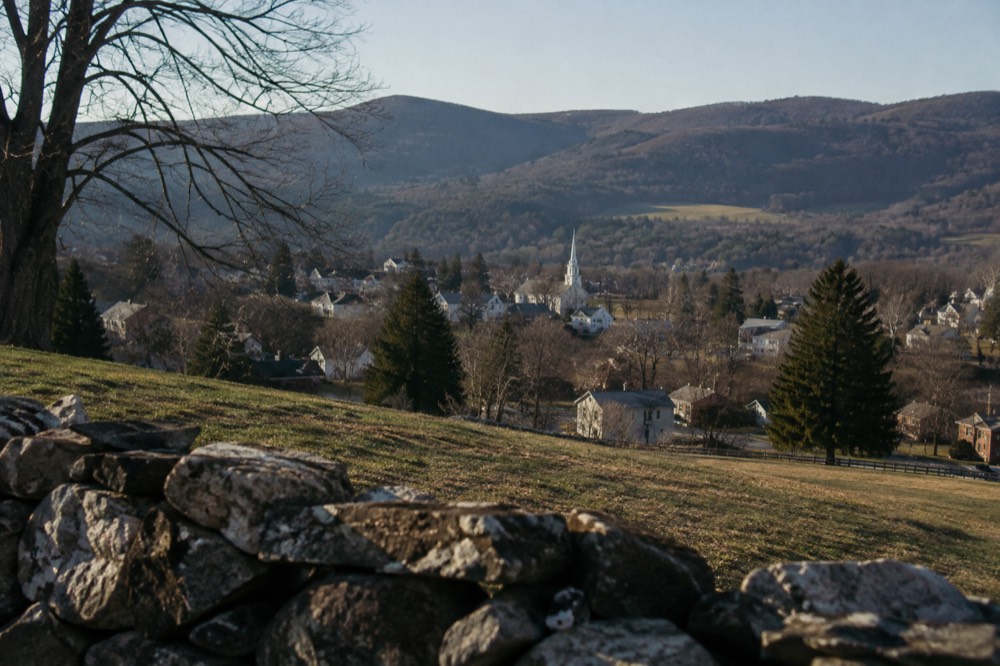 Rolling green hills and a small New England town nestled in a valley in the Berkshires