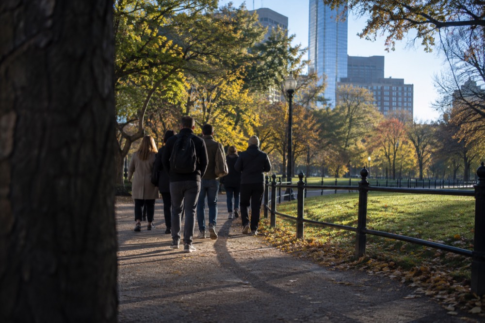 A small group of visitors walking a narrow North End street with a guide