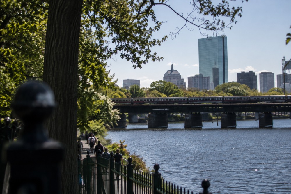 A commuter rail train crossing a bridge over a New England river