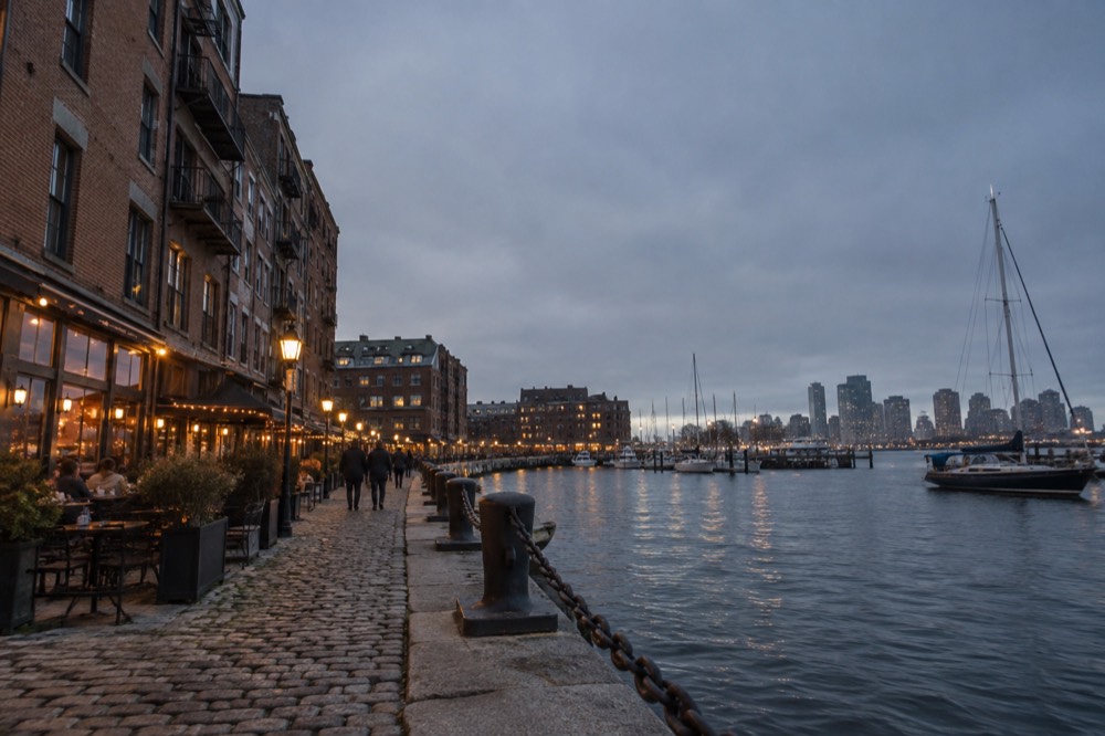 The North End waterfront at dusk with restaurant lights along the wharf