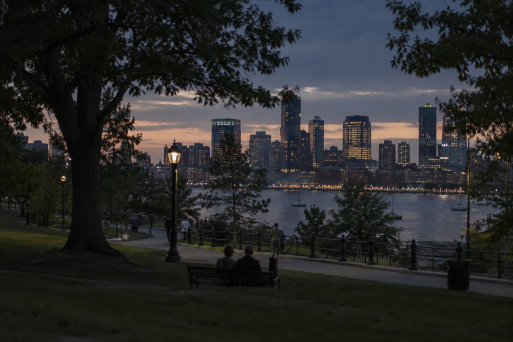 Boston skyline glowing at dusk across the harbor
