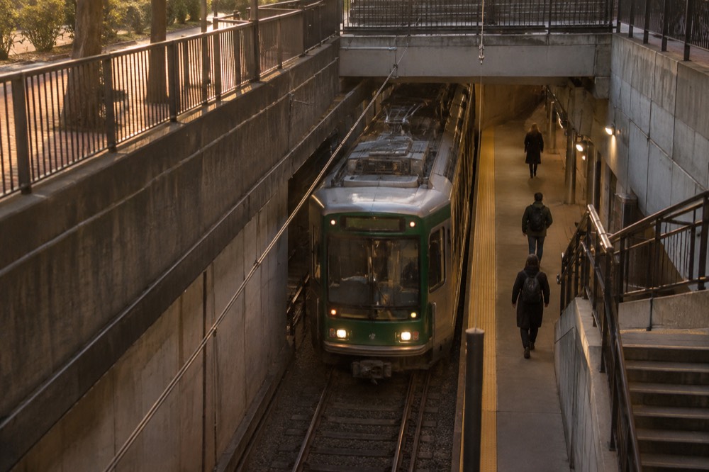 A Green Line trolley arriving at an underground MBTA station platform