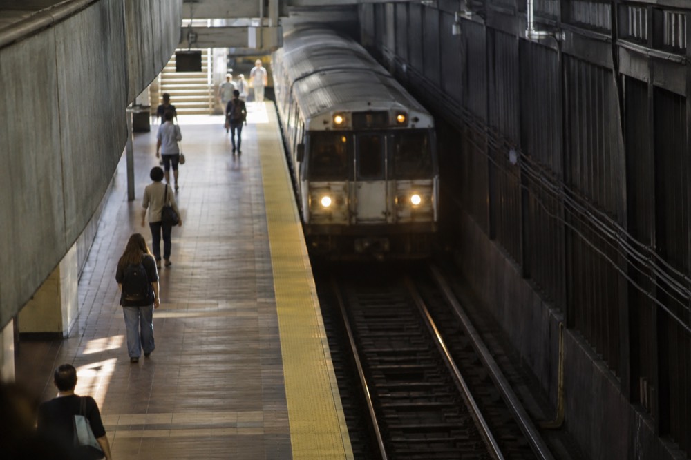 An MBTA subway station platform with a train arriving in downtown Boston