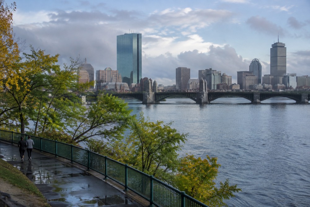 The Boston skyline seen across the Charles River with a bridge in the foreground