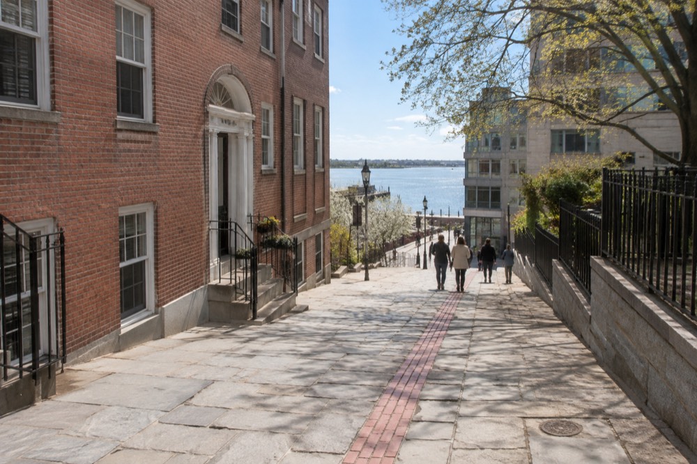 The Freedom Trail's red brick line passing historic Boston buildings