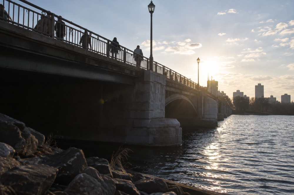 People crossing a bridge over the Charles River between Boston and Cambridge