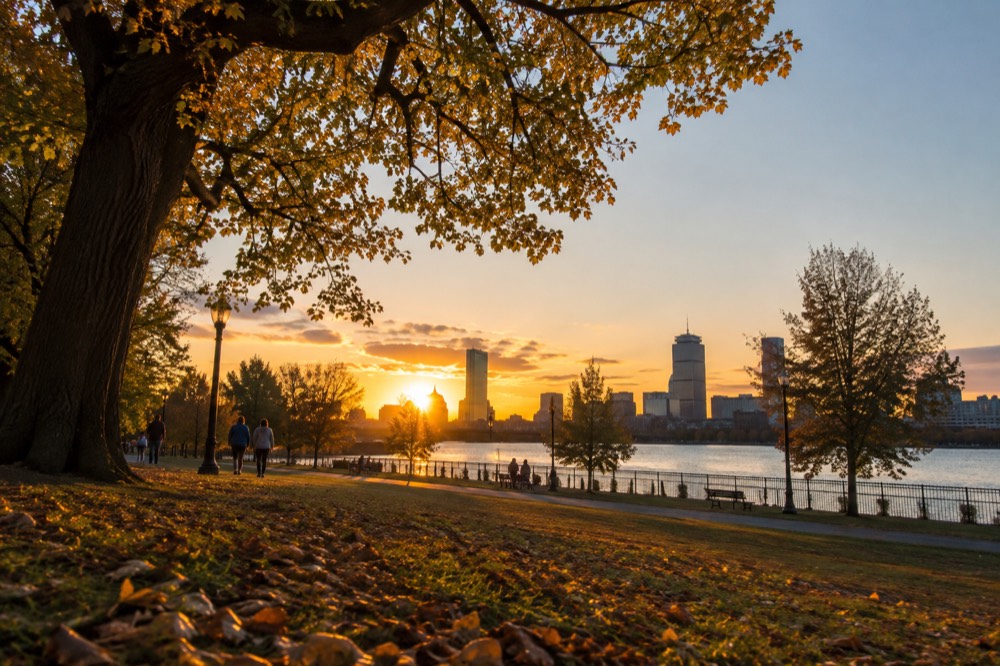 The Boston and Cambridge skylines facing each other at sunset across the river
