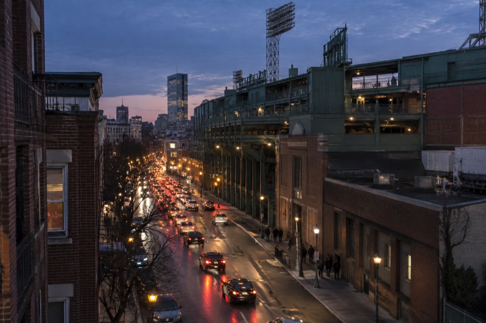The green facade and seating bowl of Fenway Park on a sunny afternoon