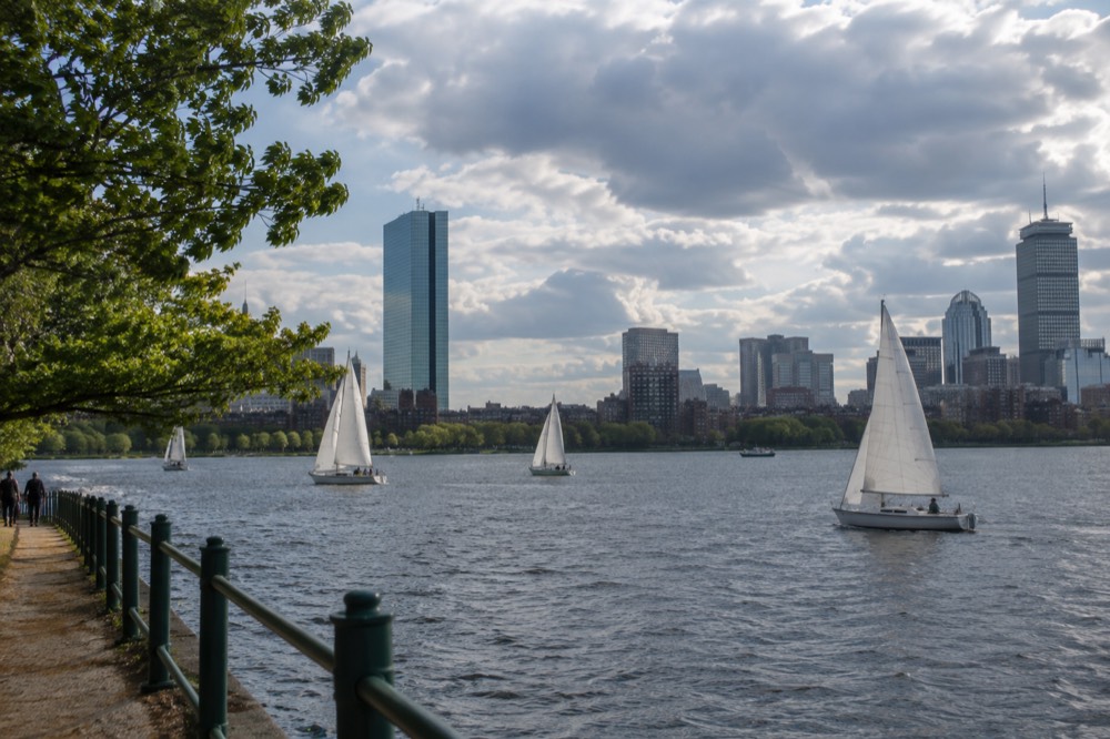 Sailboats on the Charles River with the Back Bay skyline behind them