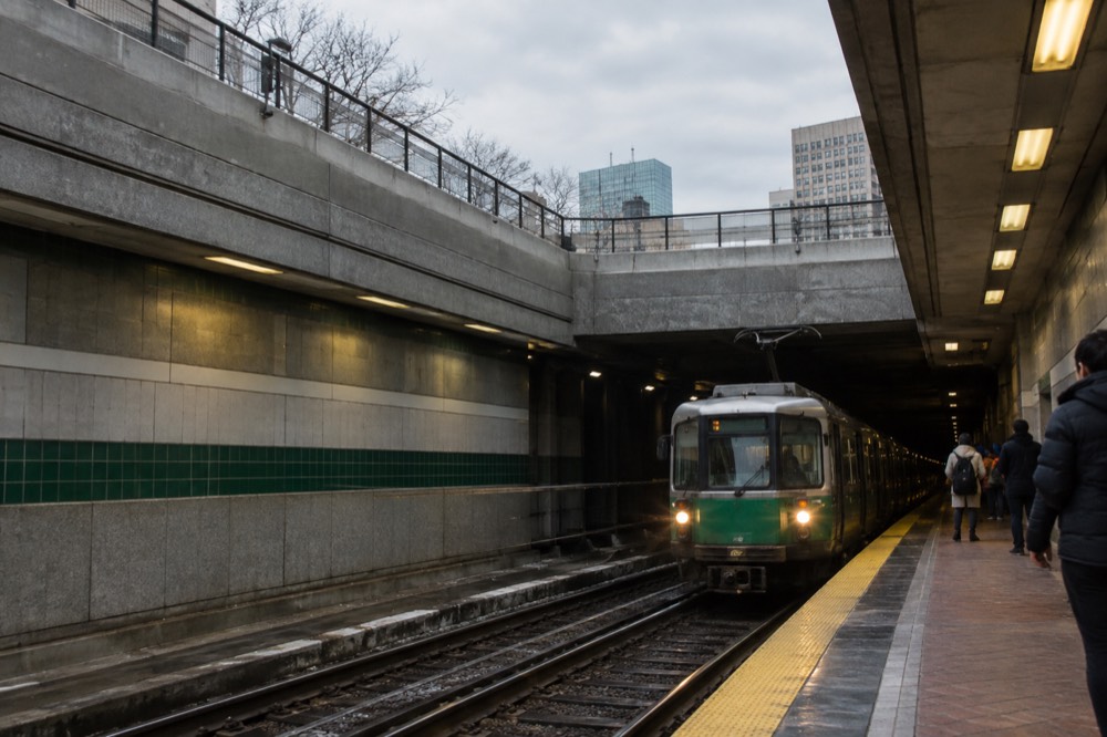 Green Line trolley arriving at an underground station platform