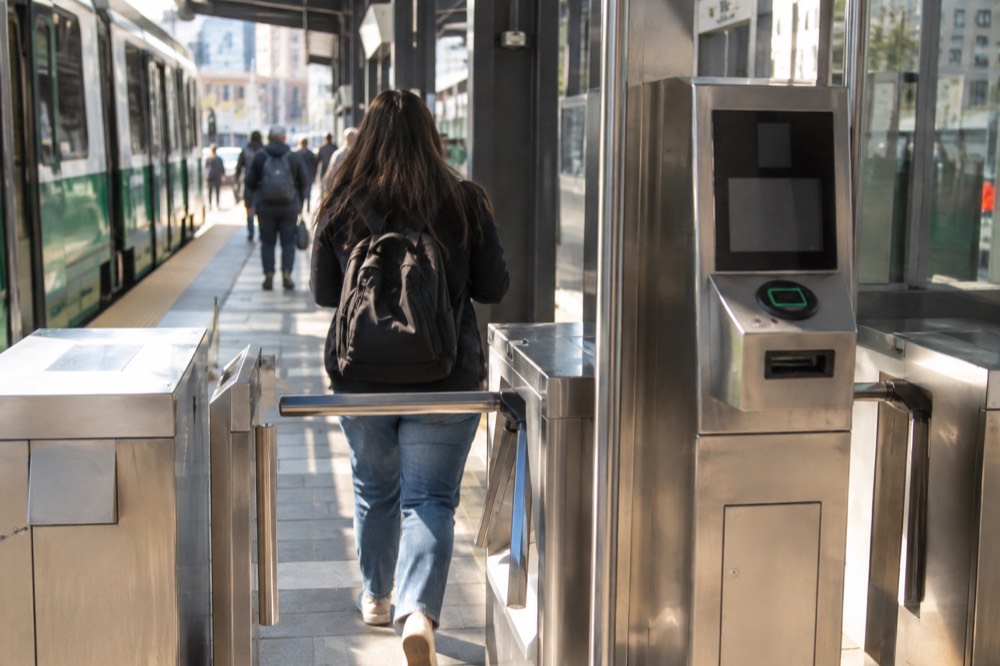 A fare machine and turnstile inside a Green Line station