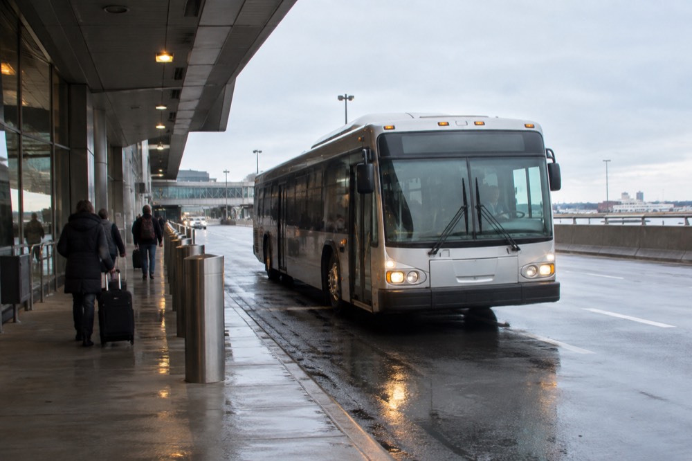 A Silver Line bus at a Logan Airport terminal curb