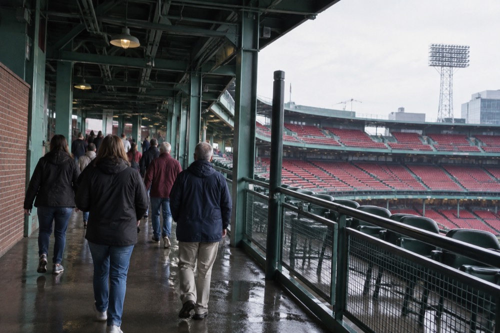 A tour group walking through the grandstand concourse at Fenway Park
