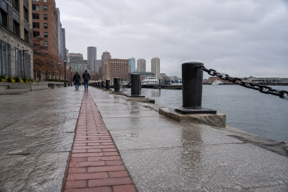 Red line on a Boston sidewalk leading toward the harbor