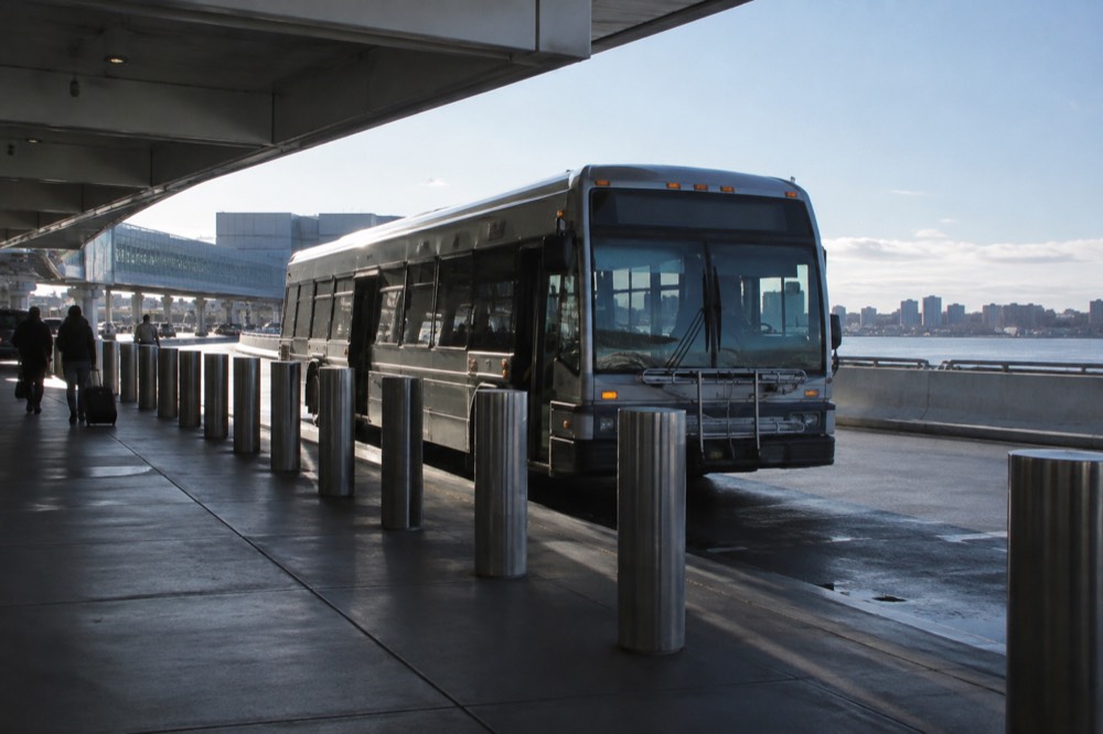 A Silver Line bus at a Logan Airport terminal curb