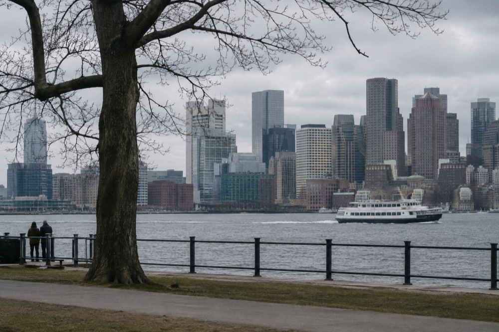 A harbor cruise boat passing the Boston skyline at midday