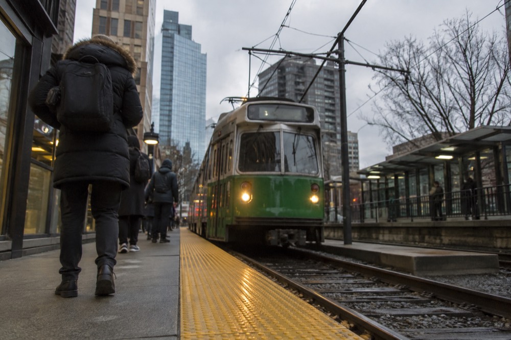A Green Line trolley arriving at an MBTA station platform