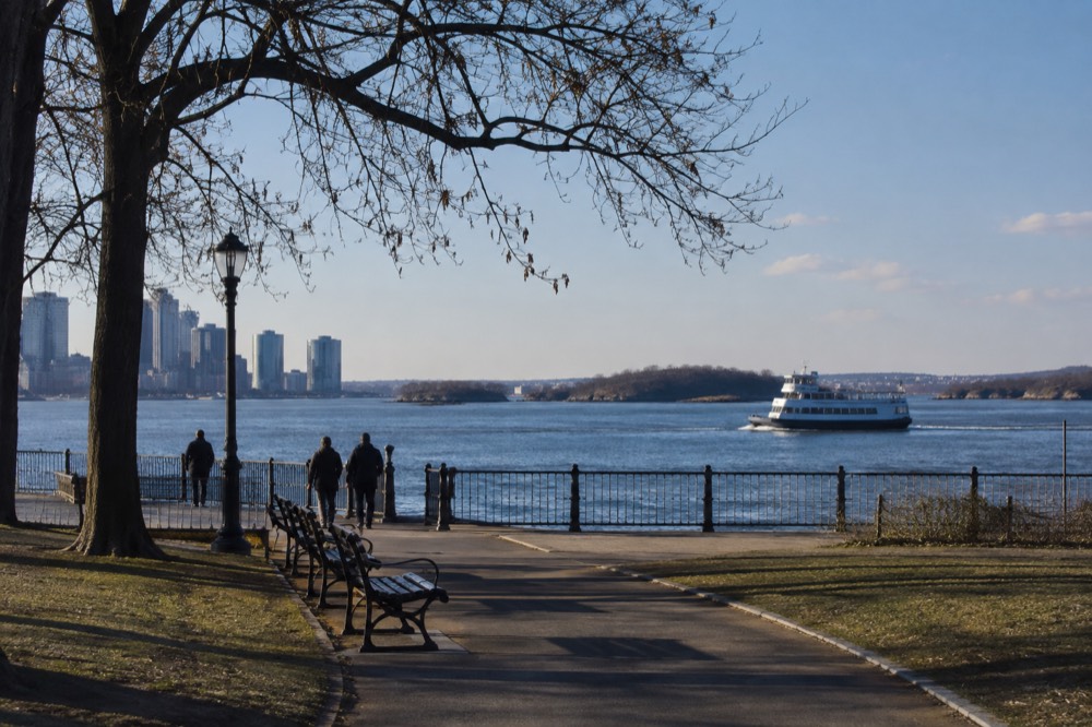 A ferry crossing Boston harbor toward green islands on a clear day