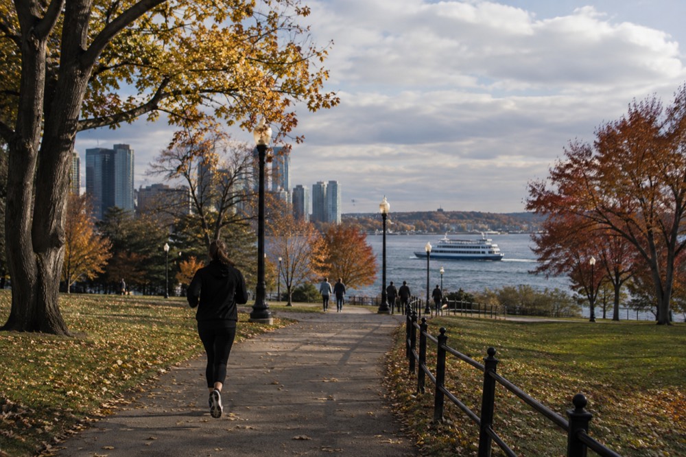 A ferry crossing the harbor toward Salem with autumn coastline in view