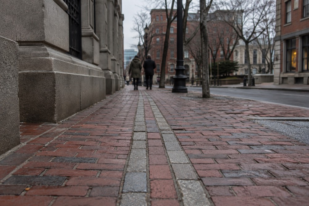 The Freedom Trail red line running along a brick sidewalk in downtown Boston