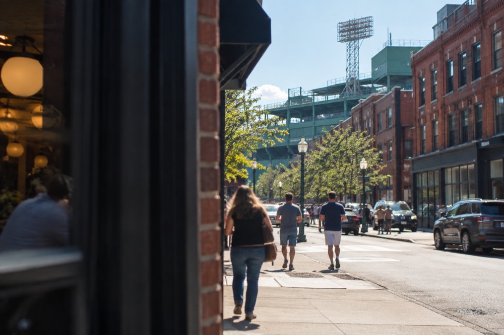 The green grandstand and Fenway Park's famous left field wall at dusk