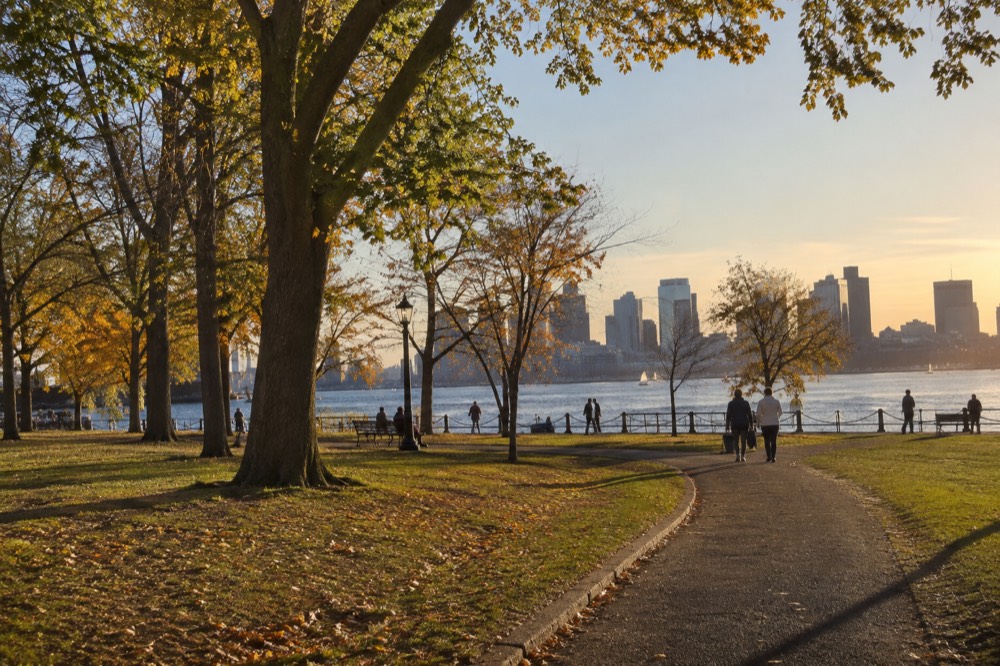 Boston's skyline seen across the harbor at golden hour