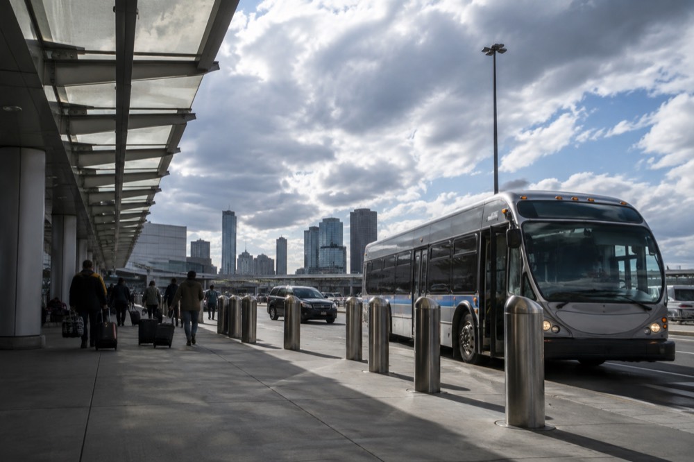 An MBTA Silver Line bus at an airport terminal curb