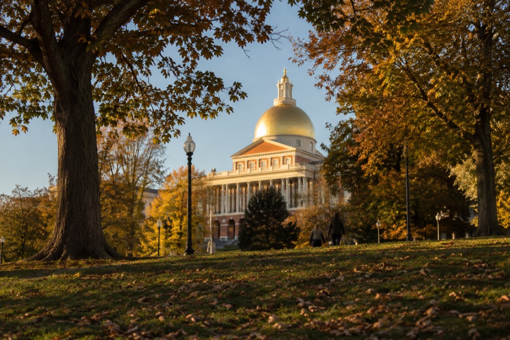 The gilded dome of the Massachusetts State House seen from Boston Common in morning light